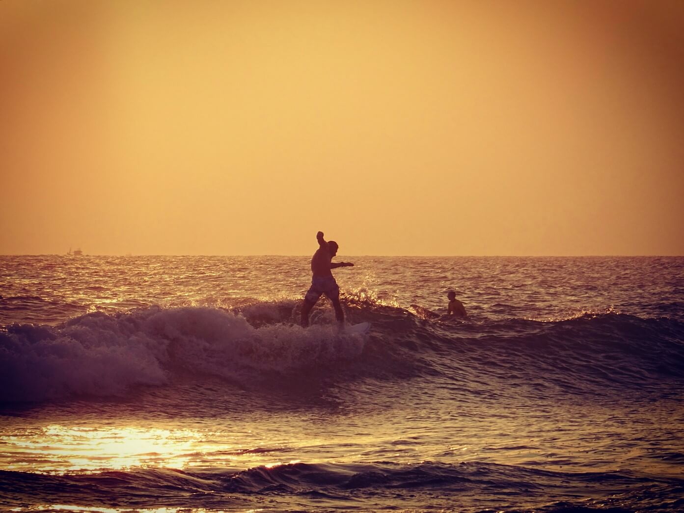 Surfer at sunset in Mirissa