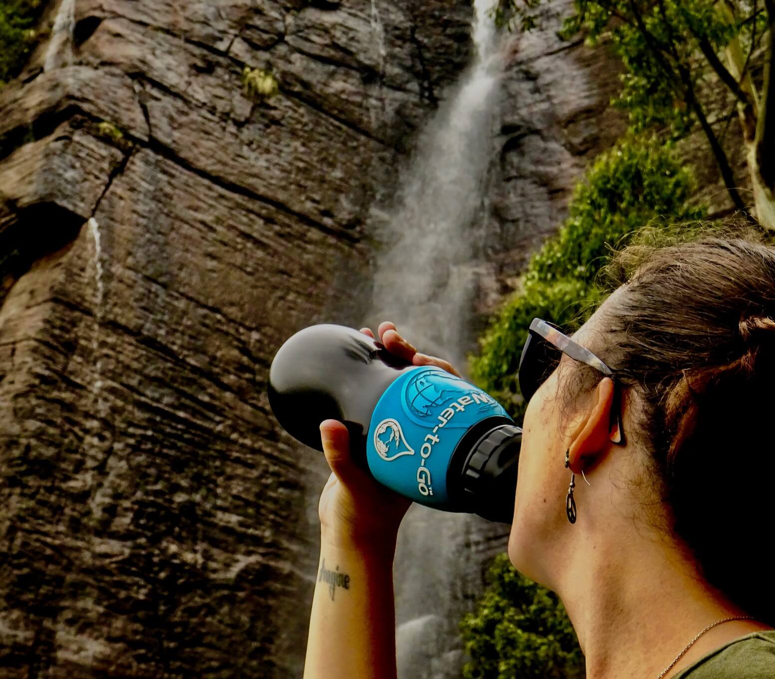 drinking from a water to go bottle smaller travel footprint
